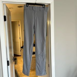 Men’s light gray baseball pants with dark green stripe down both pant legs